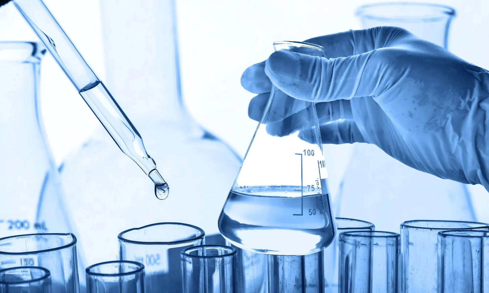 Water testing in the flask by chemist in testing laboratory